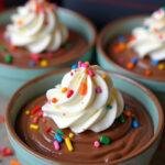 Delicious chocolate pudding inspired by Stranger Things, served with whipped cream and sprinkles for a nostalgic touch.