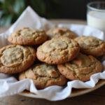 Delicious Friends Phoebe’s Vegan Cookies displayed on a rustic plate with a cup of plant-based milk, perfect for vegan dessert lovers.