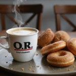 A styled breakfast tray showcasing Grey’s Anatomy O.R. coffee with an array of donuts, capturing the essence of a perfect start to the day.