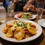 Delicious How I Met Your Mother Nachos with Cheese displayed at a lively gathering, perfect for any party or game night.