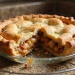Gorgeous Once Upon a Time Magic Apple Pie cooling on a countertop, showcasing its delicious apple filling and golden crust.