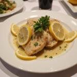 Beautifully plated Chicken Piccata, showcasing the dish with garnishes, perfect for a dining experience.