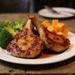 Deliciously glazed The Simpsons Pork Chops served on a rustic table, showcasing the perfect family meal.