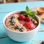 Final display of Baywatch Priyanka Chopra Jonas's Beachy Berry Smoothie Bowl, showcasing a colorful arrangement of toppings against a tropical backdrop.