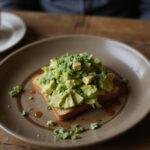 Delicious Brooklyn Nine-Nine Charles Boyle's Artisanal Avocado Toast ready to be enjoyed, perfect for brunch.