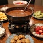 A stunning dessert spread with chocolate fondue, surrounded by colorful dippables, inspired by Charlie and the Chocolate Factory Augustus Gloop's Chocolate River Fondue, perfect for any gathering.