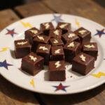 Delicious squares of Dragon Ball Beerus' Destruction Divinity Fudge displayed creatively on a plate.