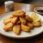 Final presentation of Dragon Ball Master Roshi's Turtle School Tempura, featuring crispy tempura with dipping sauce, looking appetizing on a rustic wooden table.