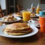 A cozy breakfast scene featuring Gilmore Girls Al's Pancake World Pancakes, coffee, and fresh fruit.
