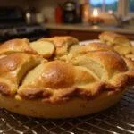 Delicious finished apple pie from How I Met Your Mother Ted Mosby's Architect's Apple Pie recipe, showcasing a golden-brown crust and inviting kitchen scenery.