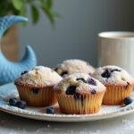 Delicious How I Met Your Mother The Blue French Horn Blueberry Muffins displayed on a plate, perfect for serving with coffee.