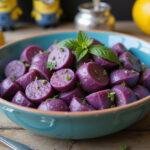 Delicious Minions Evil Minion Purple Potato Salad served in a vibrant bowl, perfect for gatherings, showcasing its fun color and garnishes.