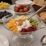 Final presentation of Modern Family Dunphy's Delightful Dessert Dip on a decorative table, inviting and ready to be served.