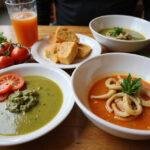 A stunning table setting with Squid Game Red Light, Green Light Gazpacho and fresh ingredients, perfect for an inviting and refreshing dining experience.