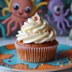 Gorgeous Squid Game The VIPs' Velvet Cupcake finished with cream cheese frosting, beautifully presented on a plate, ready to be enjoyed.