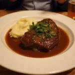 Deliciously presented The Simpsons Duff Beer-Braised non-alcoholic Short Ribs, showcasing the perfect finish of this savory dish.