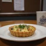 A realistic scene of Captain Holt's Classic Quiche on a plate in the Brooklyn Nine-Nine precinct kitchen. The quiche has a crispy crust and creamy filling, garnished with herbs, with police station elements and Brooklyn Nine-Nine-themed objects in the background.
