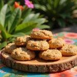 Plate of Disney-inspired Lilo and Stitch Ohana Outrigger Oatmeal Cookies set on a tropical picnic table with Hawaiian decorations, highlighting the warm, homemade cookies in a lush, island-themed environment.