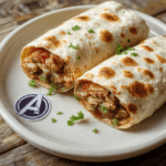 Colorful Marvel Avengers Shawarma Wraps wrapped in parchment paper with a golden-brown crispy tortilla shell peeking out, filled with juicy grilled chicken strips, fresh lettuce, tomatoes, red onions, tzatziki sauce, and a hint of garlic aioli, garnished with fresh parsley and a small Avengers shield sticker on the side.