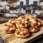 Golden-brown, slightly blistered möbius-folded pizza pockets on a crumpled paper towel-lined wooden board, oozing melted mozzarella and spicy rocoto pepper filling, dusted with red pepper flakes and fresh basil, against a subtle Brooklyn street backdrop with graffiti art and distant subway sign